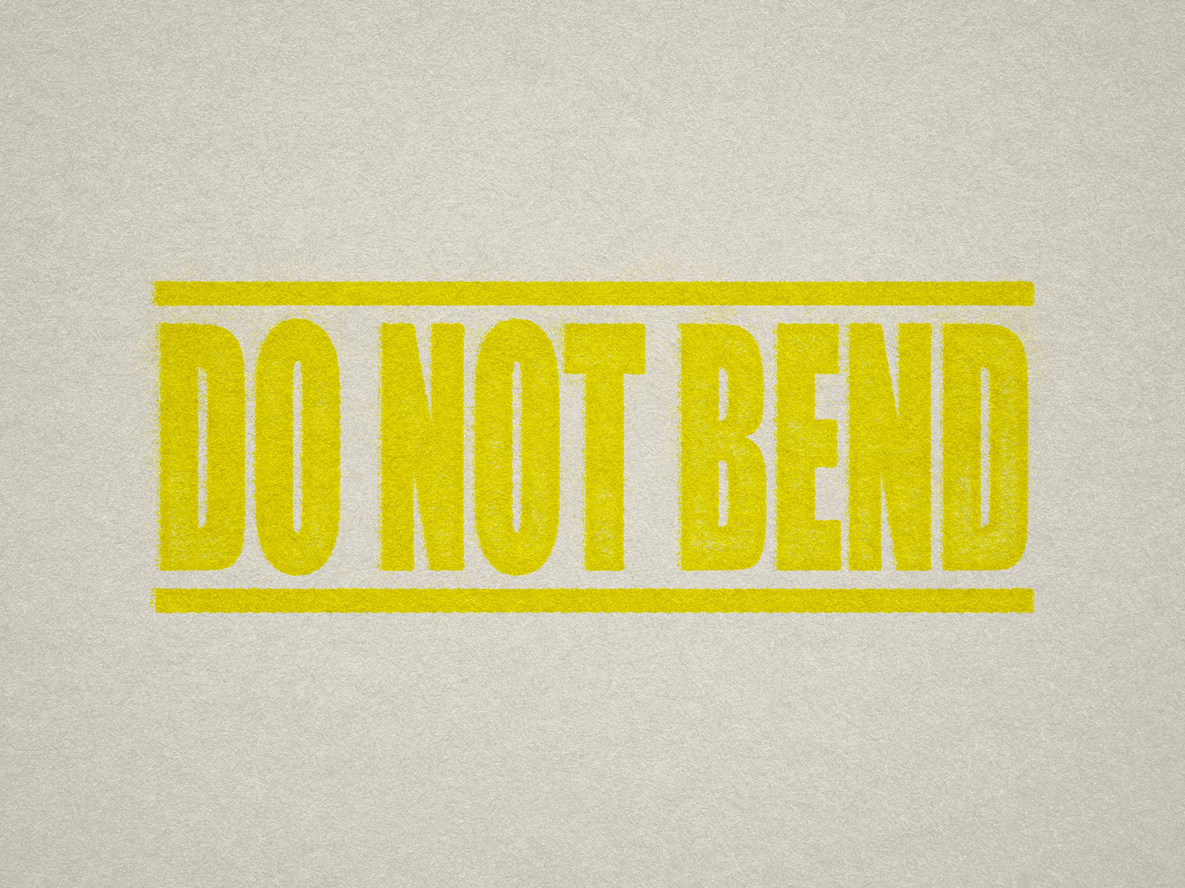 mock up design of DO NOT BEND rubber stamp yellow ink in paper background stampers hand stamp office business inventory documents