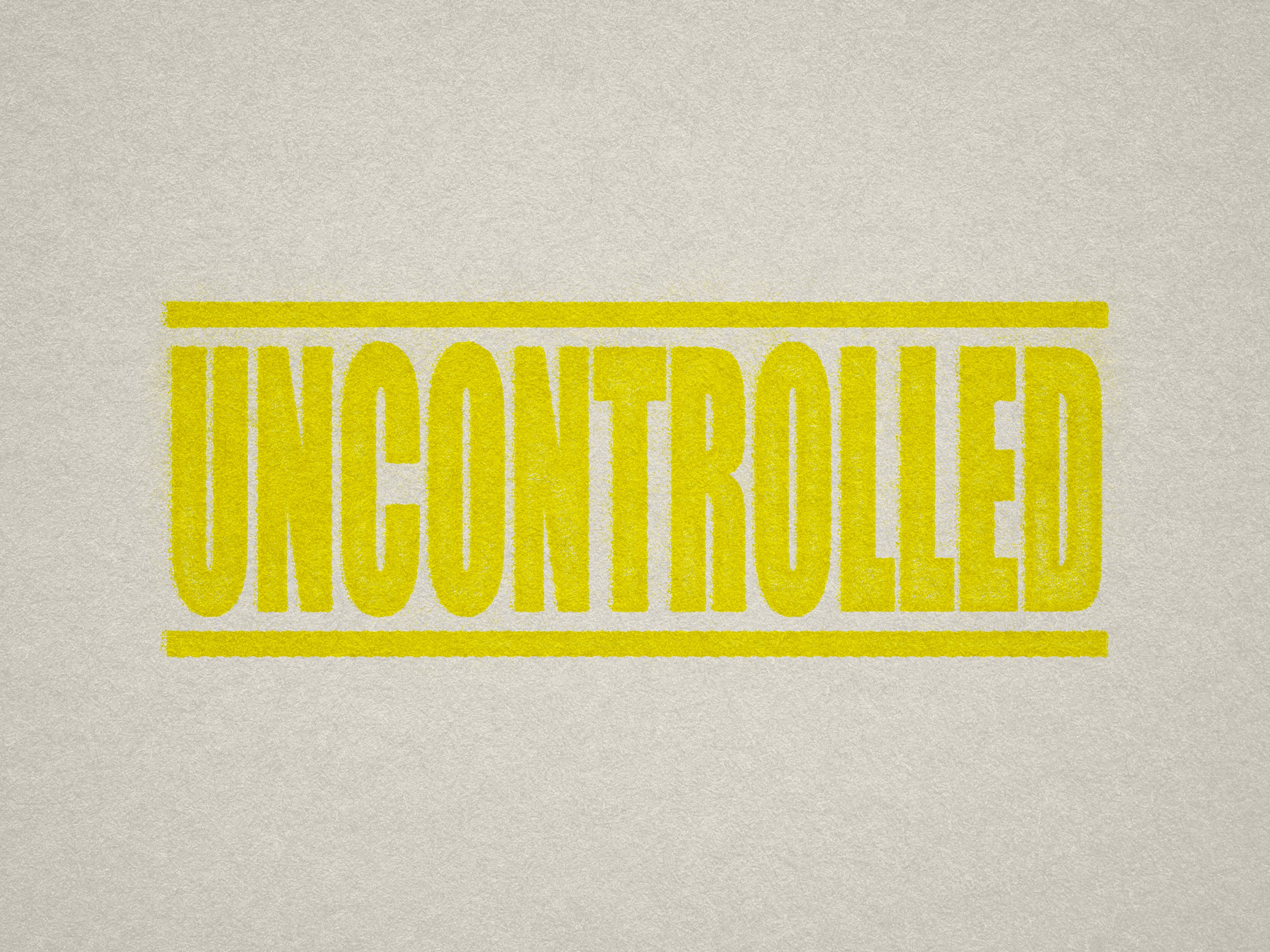 Mock up design or lifestyle image of 'UNCONTROLLED' rubber stamp yellow ink in paper background stampers hand stamp office business inventory documents self inking prefill refillable stamps stamping