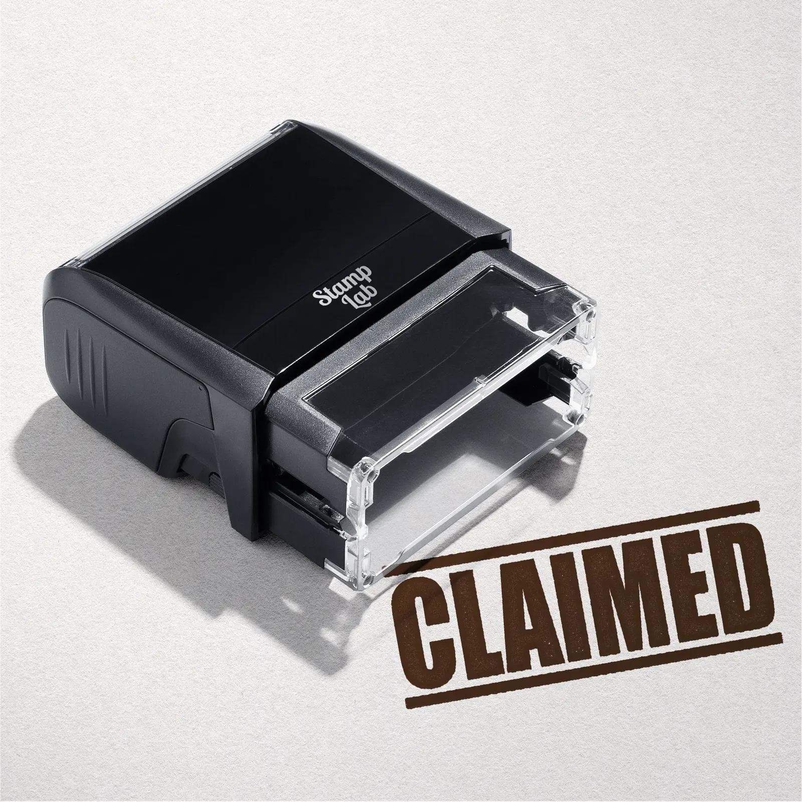 mock up design or lifestyle image of 'Claimed' rubber stamp brown ink in paper background stampers hand stamp office business inventory documents self inking prefill refillable stamps stamping
