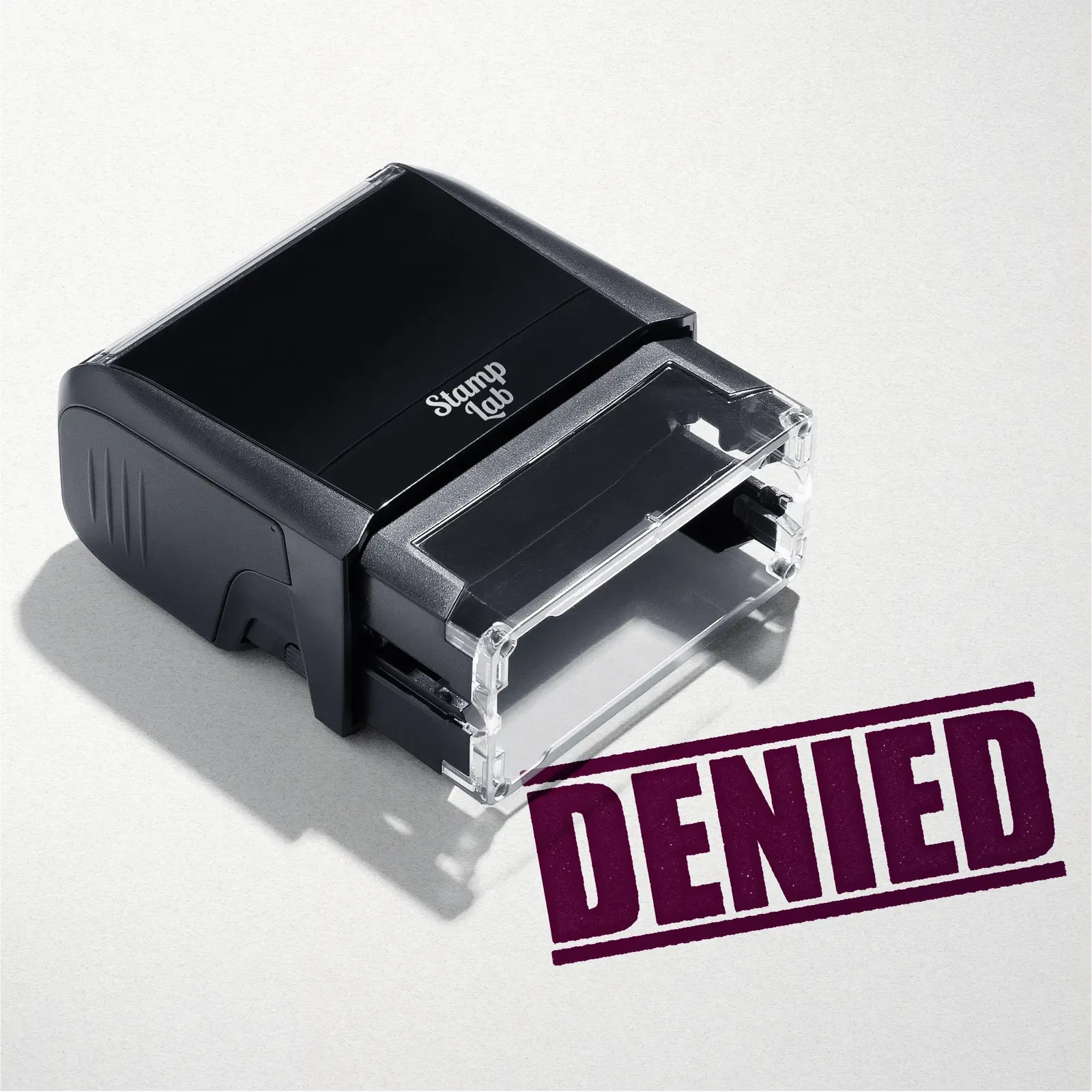 mock up design or lifestyle image of 'Denied' rubber stamp maroon ink in paper background stampers hand stamp office business inventory documents self inking prefill refillable stamps stamping