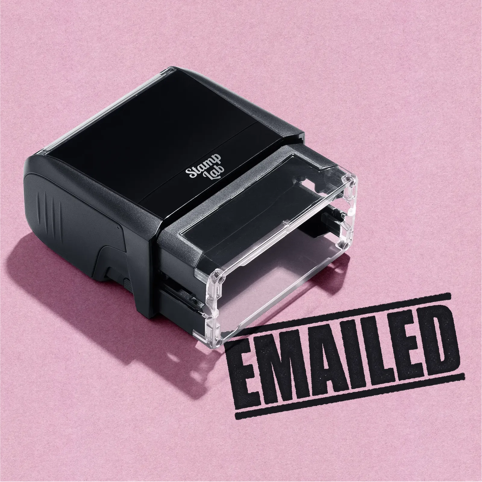 A black self inking rubber stamp with the word 'EMAILED' printed in bold capital letters in black ink. stampers hand stamp office business inventory documents