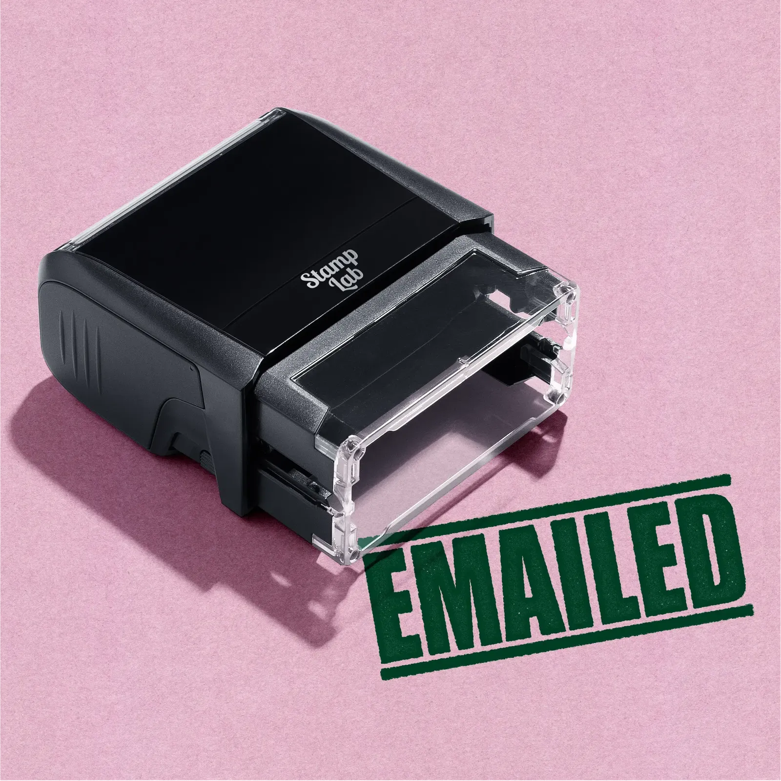 A green self inking rubber stamp with the word 'EMAILED' printed in bold capital letters in green ink. stampers hand stamp office business inventory documents