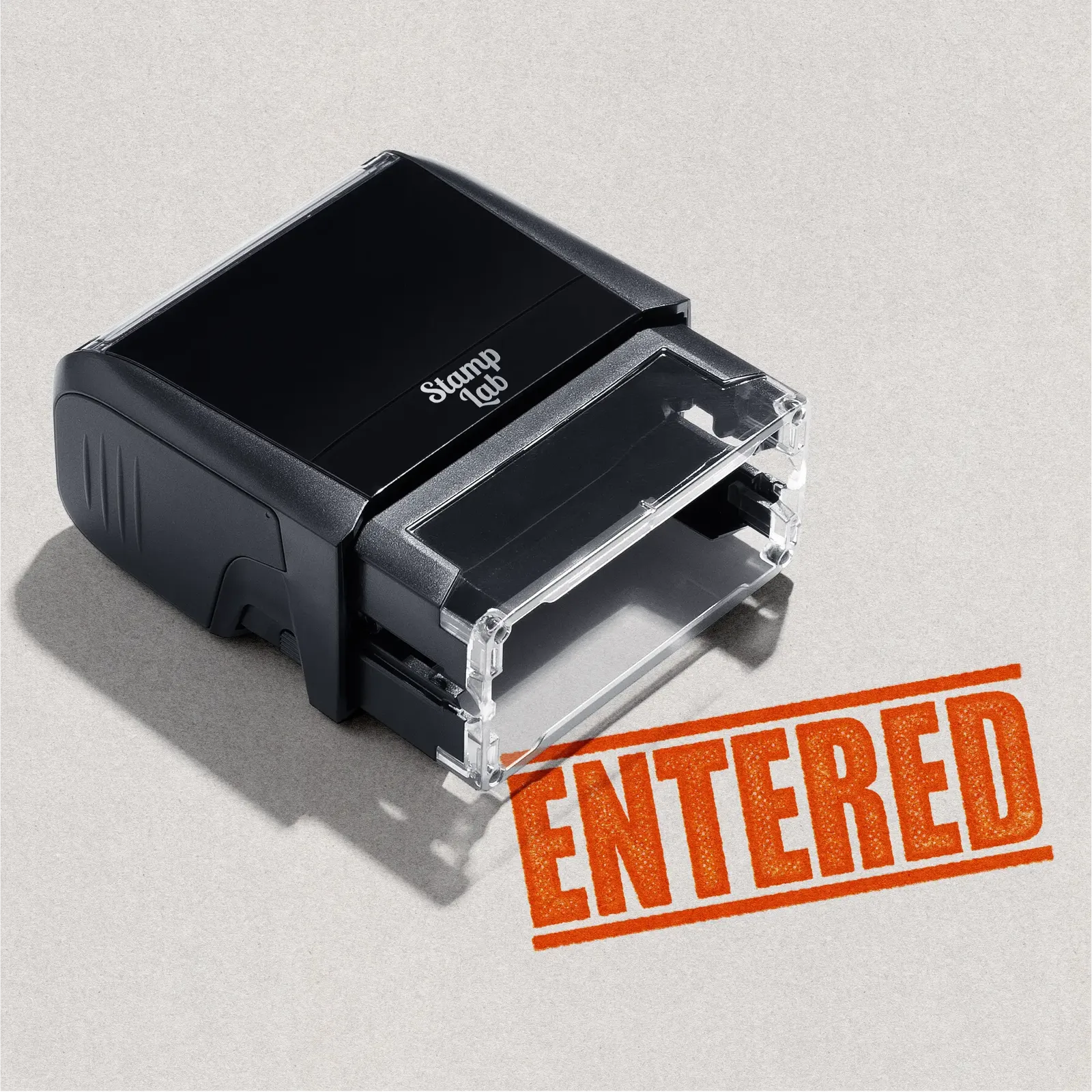 Mock up design or lifestyle image of 'ENTERED' rubber stamp orange ink in paper background stampers hand stamp office business inventory documents orange