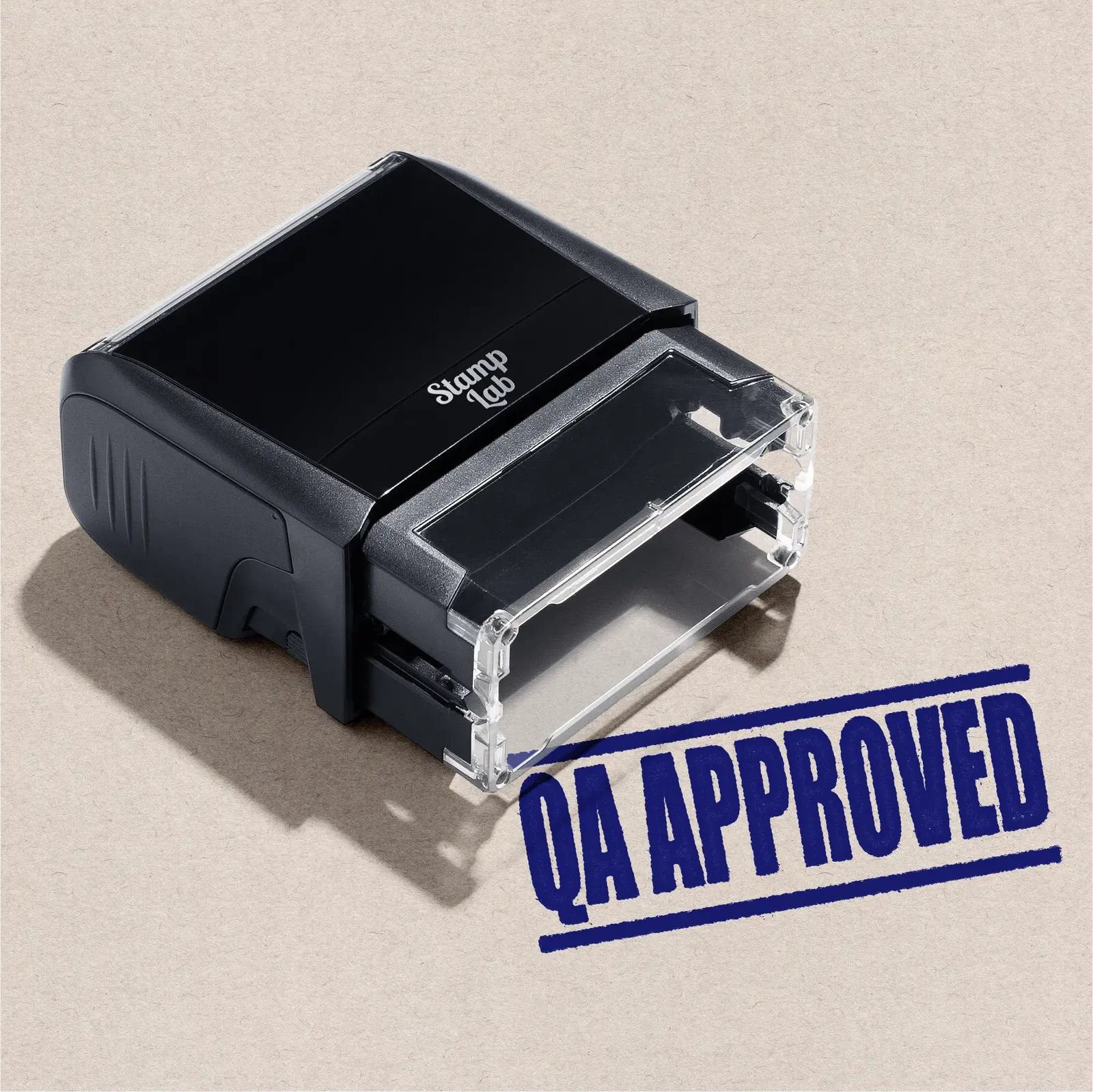 self-inking stamp with 'QA Approved' design blue ink on beige background