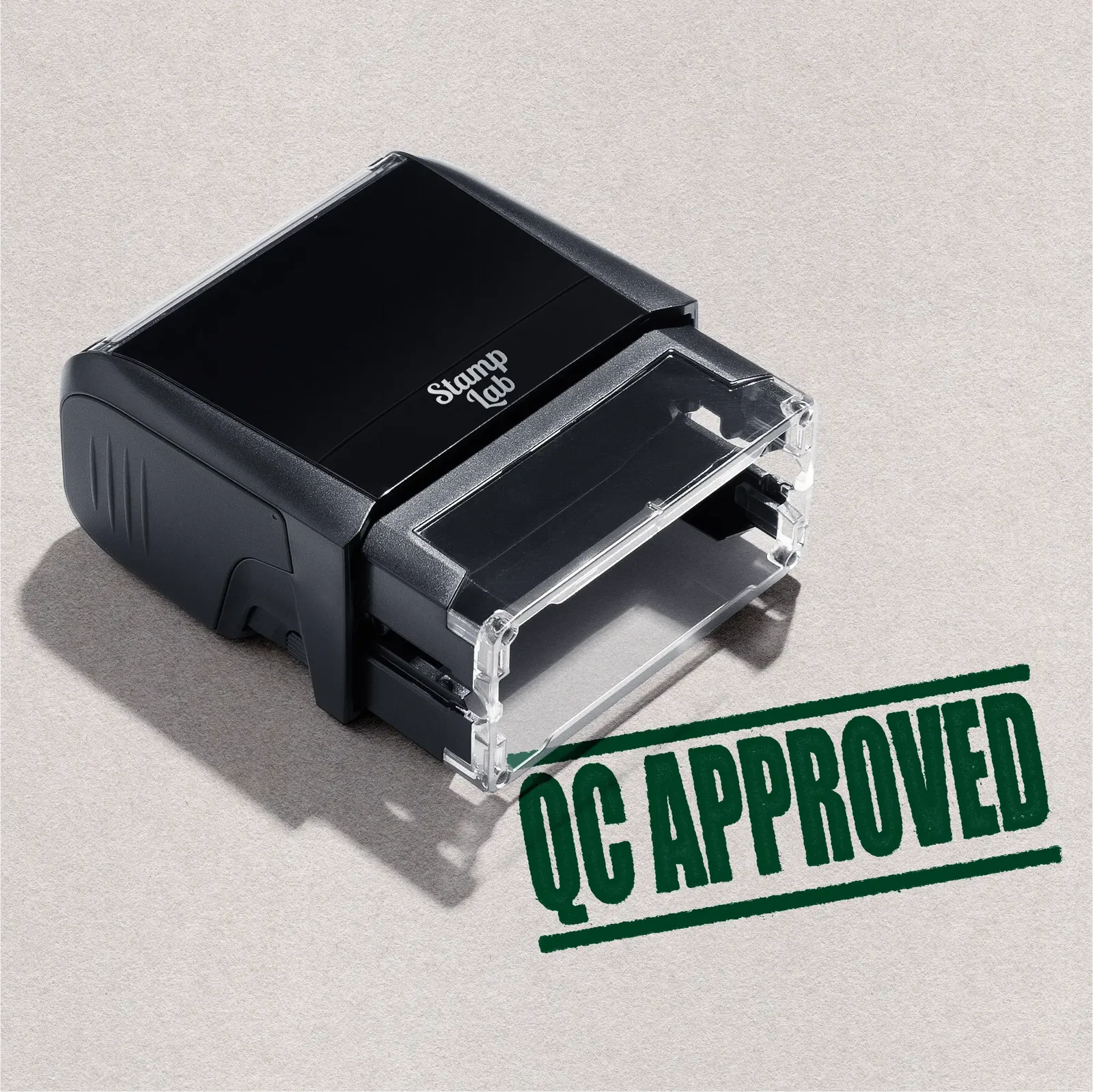 self-inking stamp with 'QC Approved' design in green ink