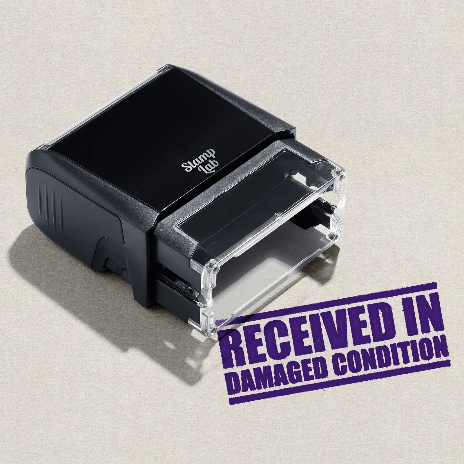 Black self-inking stamp purple ink reading 'Received in Damaged Condition'