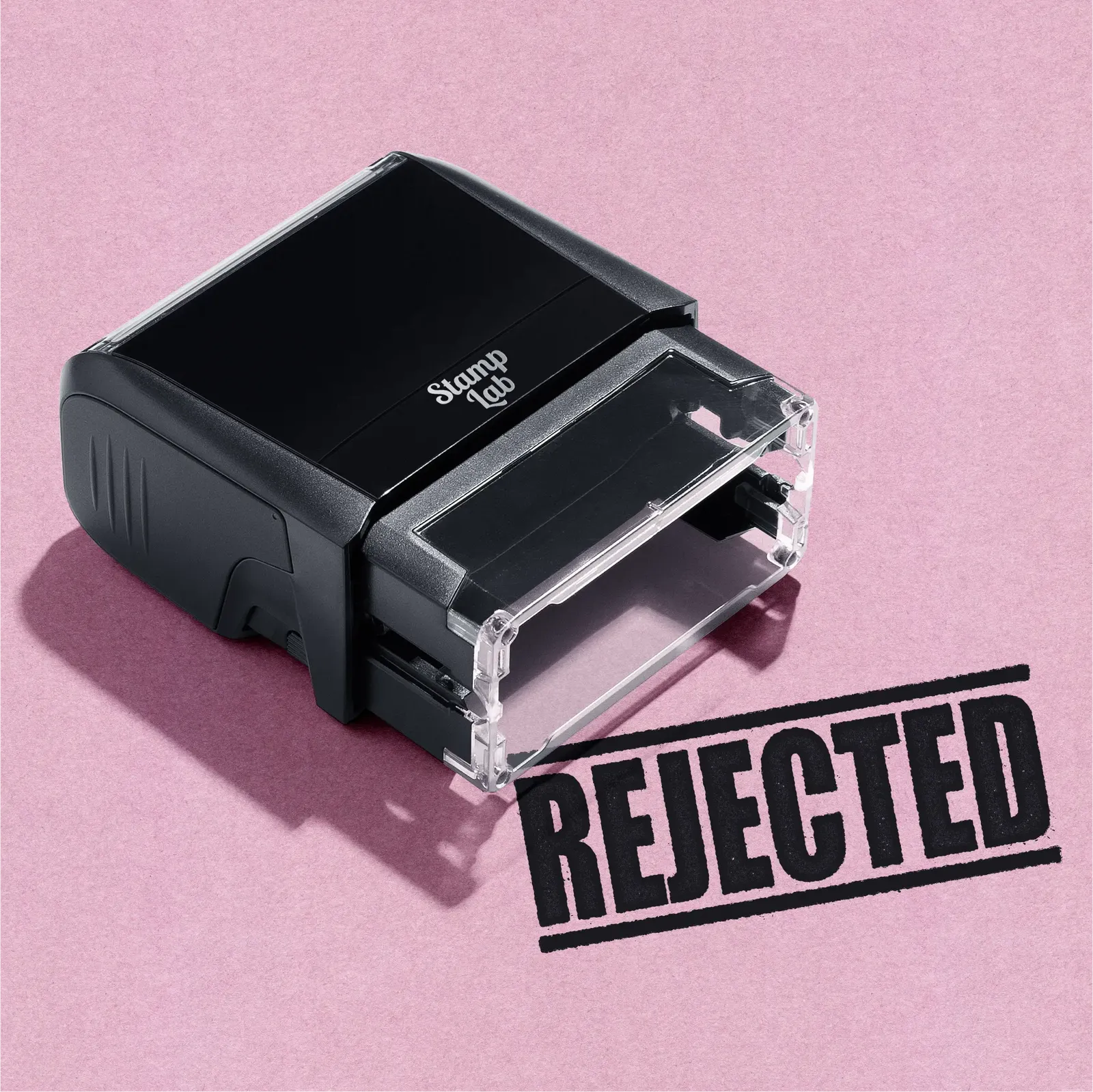 Black stamp with 'REJECTED' text on a pink background