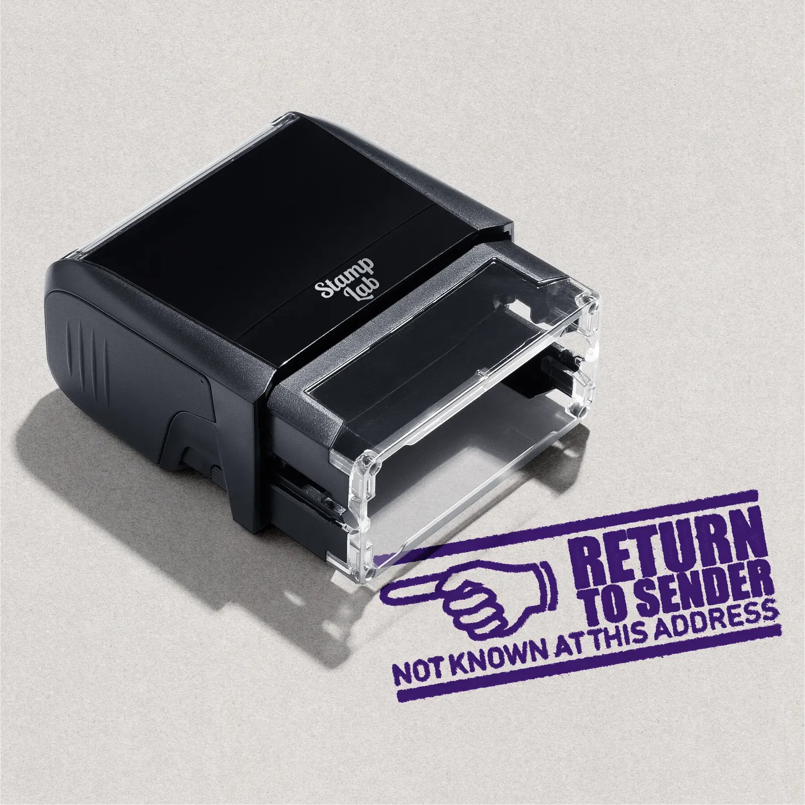 Violet self-inking rubber stamp with the text 'RETURN TO SENDER' design