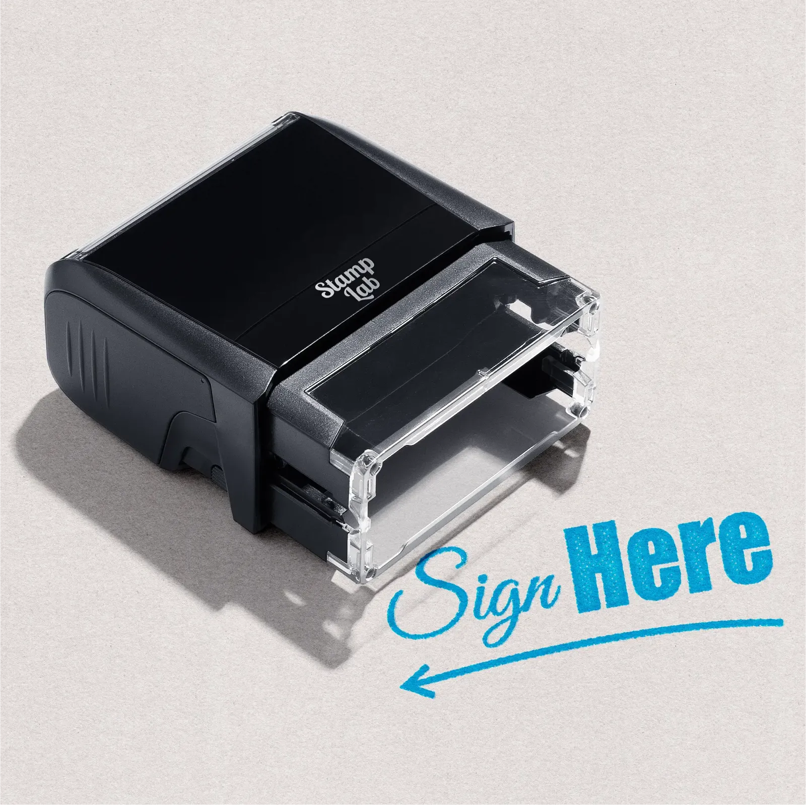 Black self-inking rubber stamp 'Sign Here' text in a light blue ink