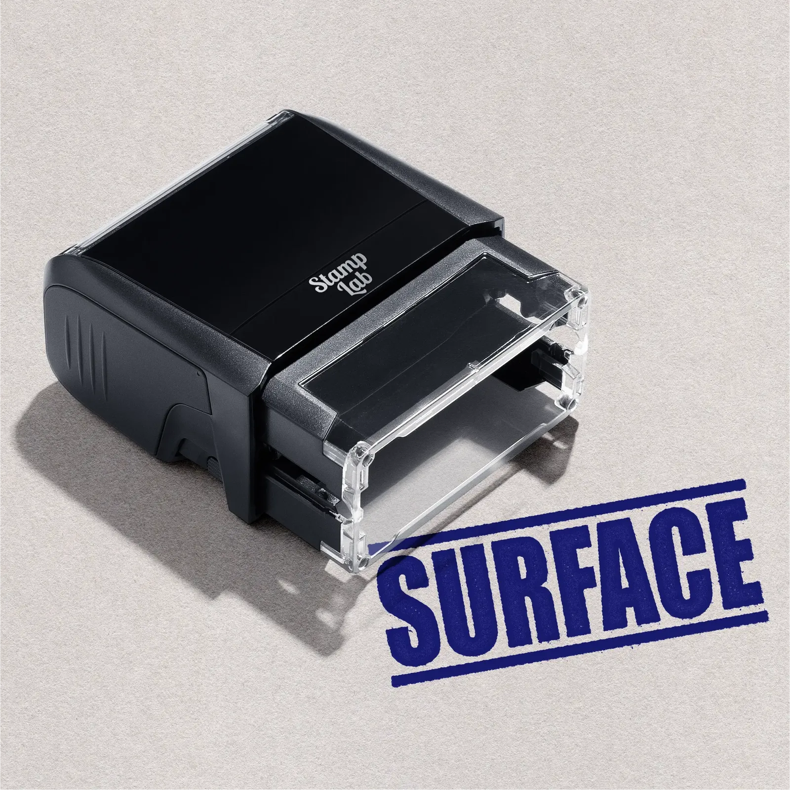 Black self-inking stamp with 'Surface' text in blue ink