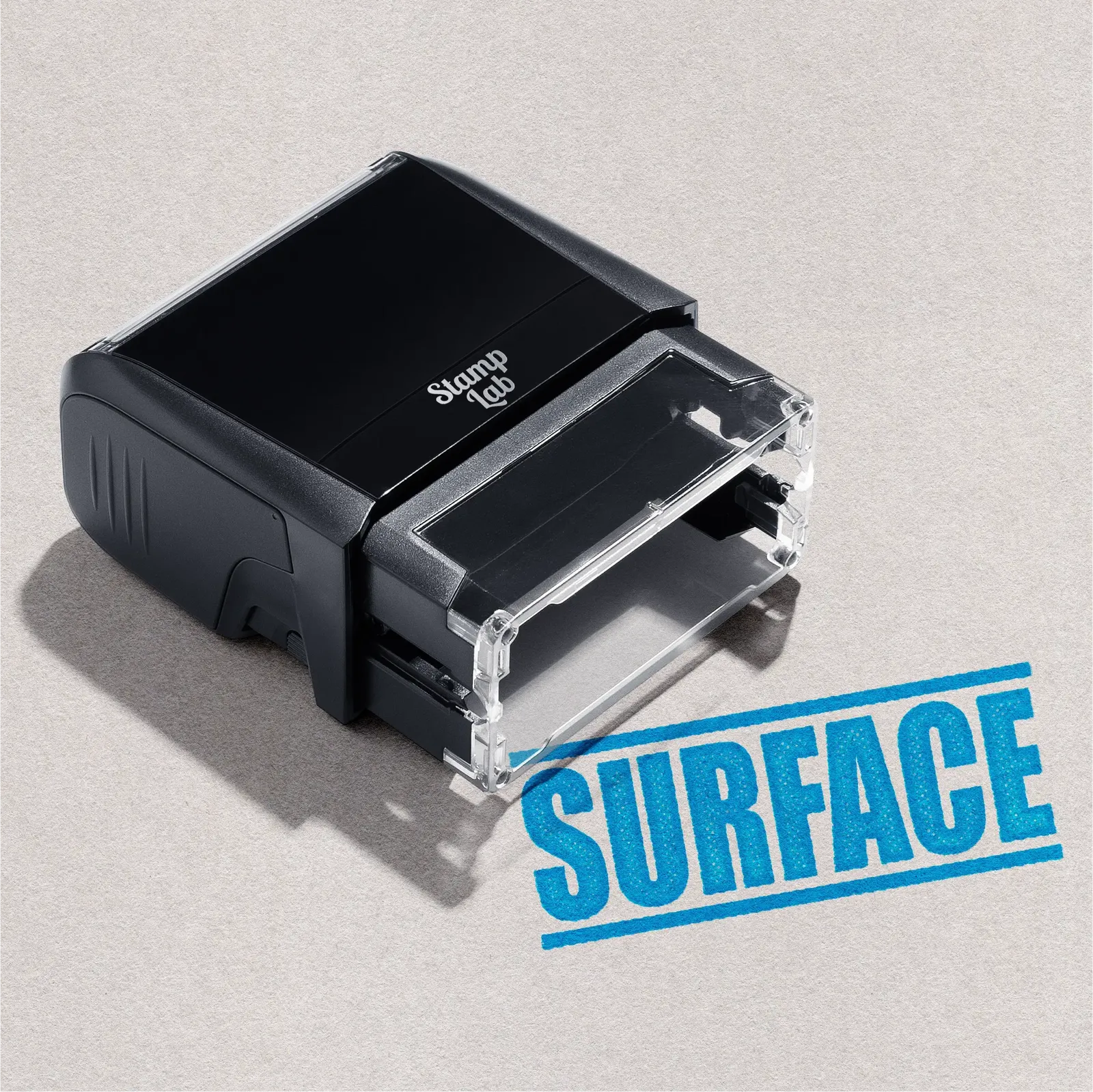 Black self-inking stamp with readymade 'SURFACE' design turquoise ink