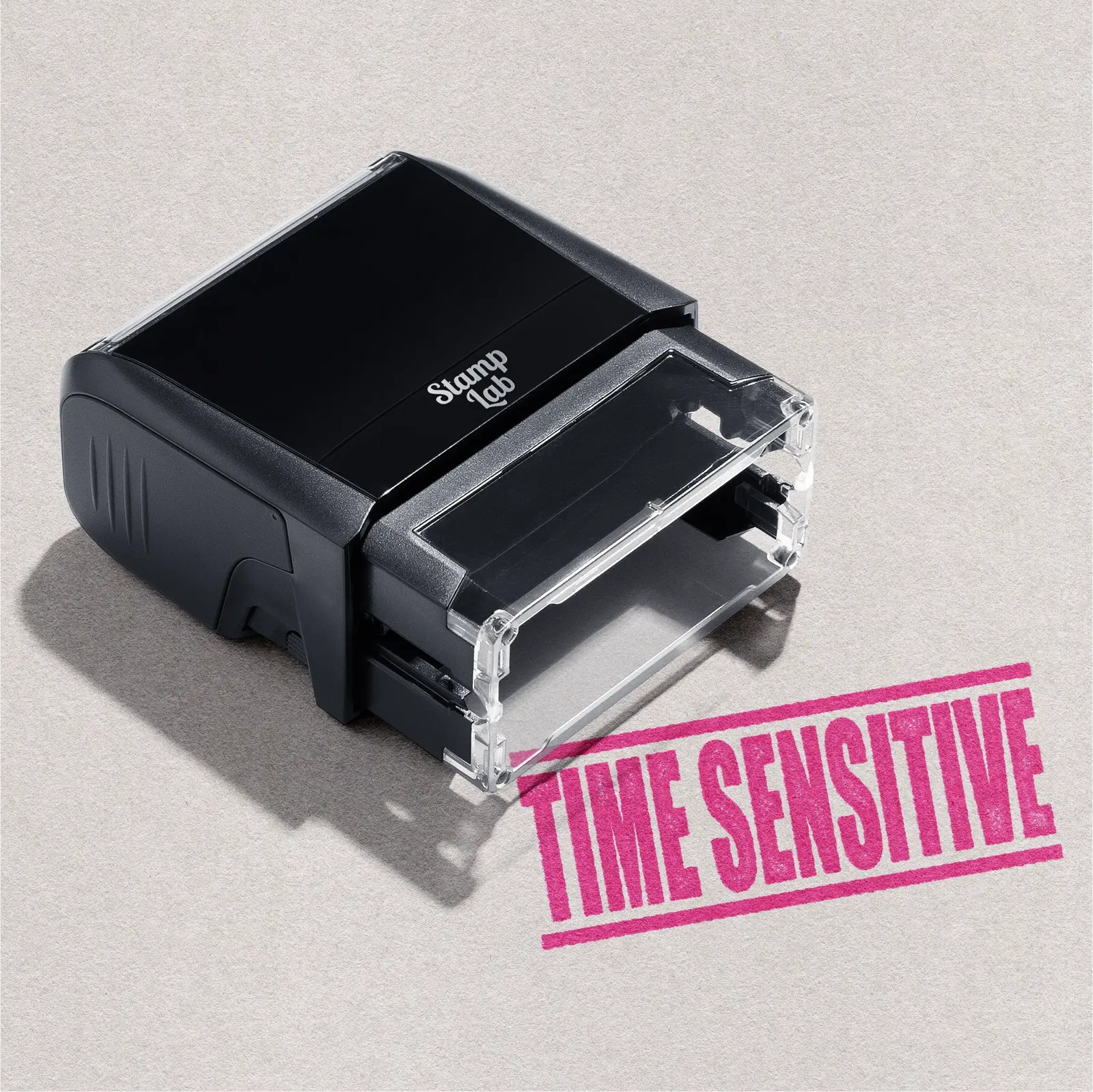 Black self-inking stamp with 'TIME SENSITIVE' design Pink ink