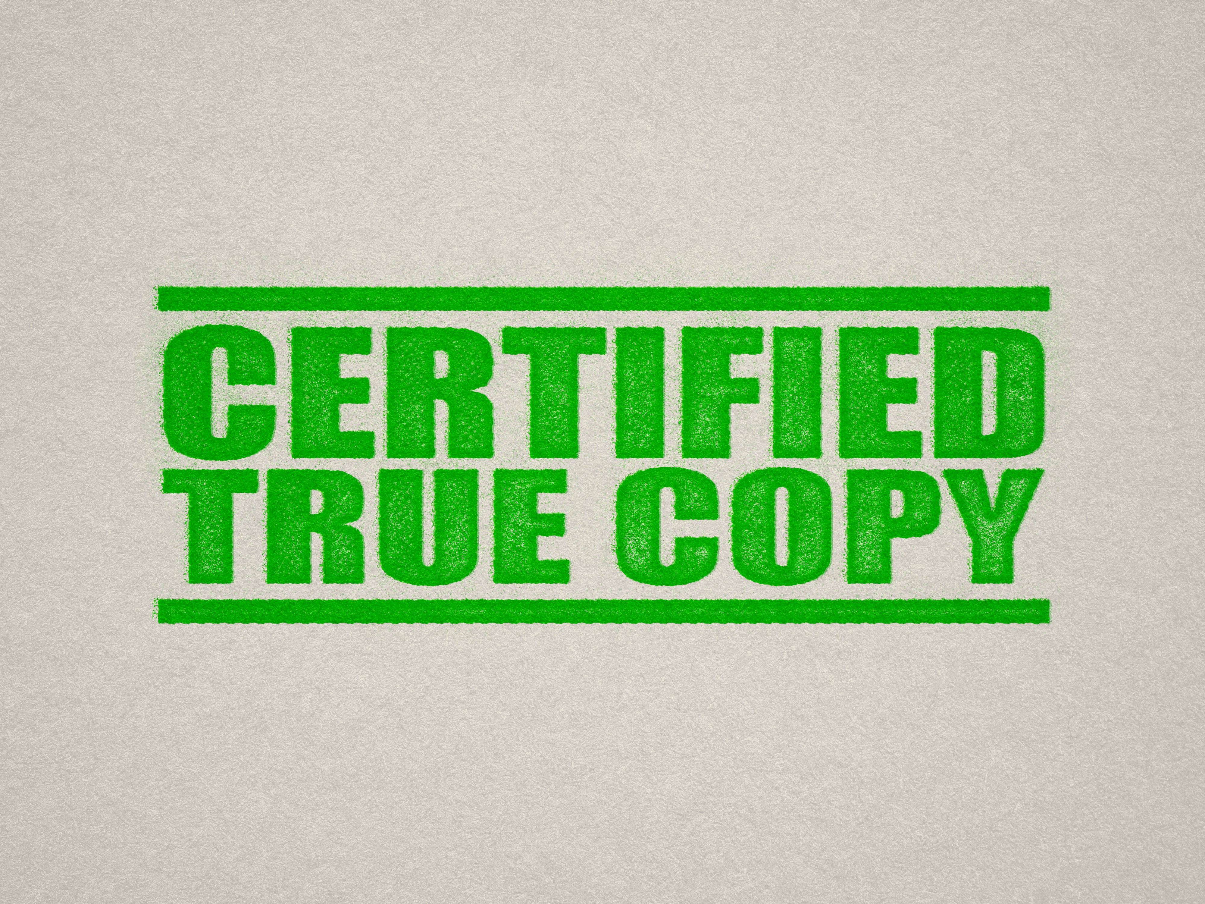 mock up design of 'Certified True Copy' rubber stamp apple green ink in paper background stampers hand stamp office business inventory documents self inking prefill refillable stamps stamping