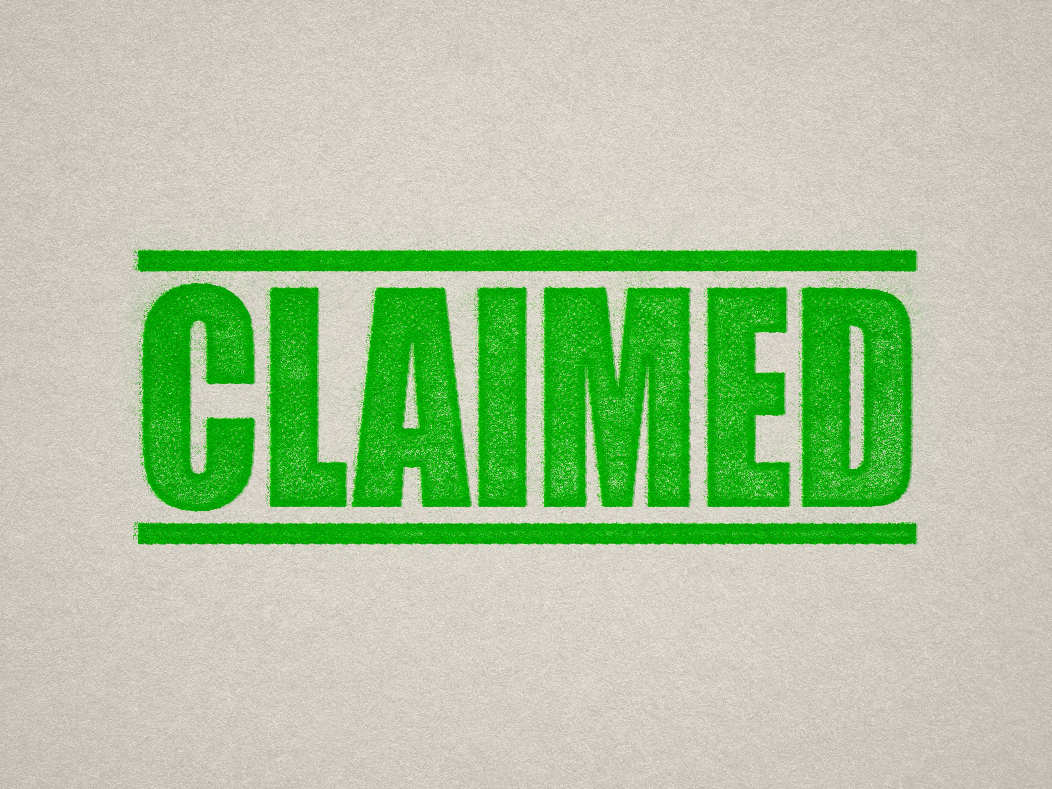 mock up design of 'Claimed' rubber stamp apple green ink in paper background stampers hand stamp office business inventory documents self inking prefill refillable stamps stamping