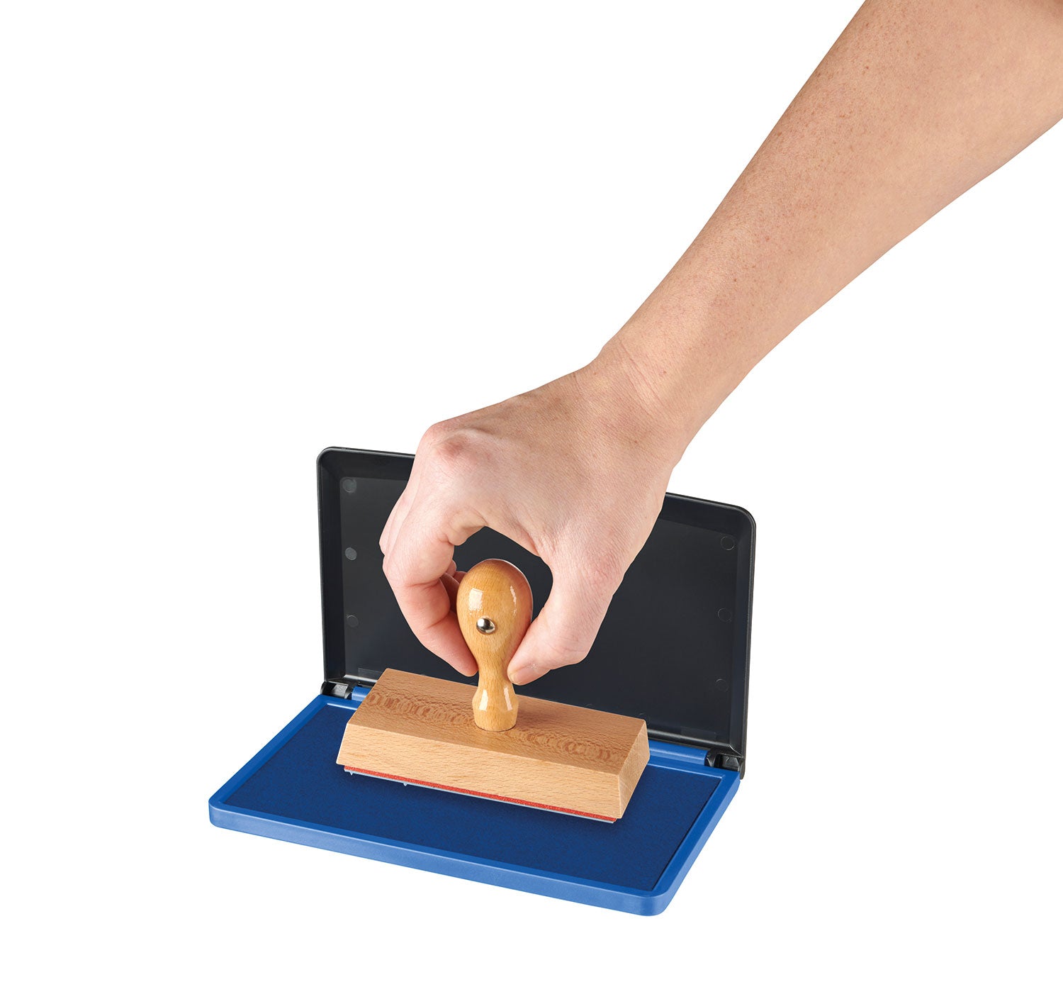 hand stamping wood stamp in large blue stamp pad