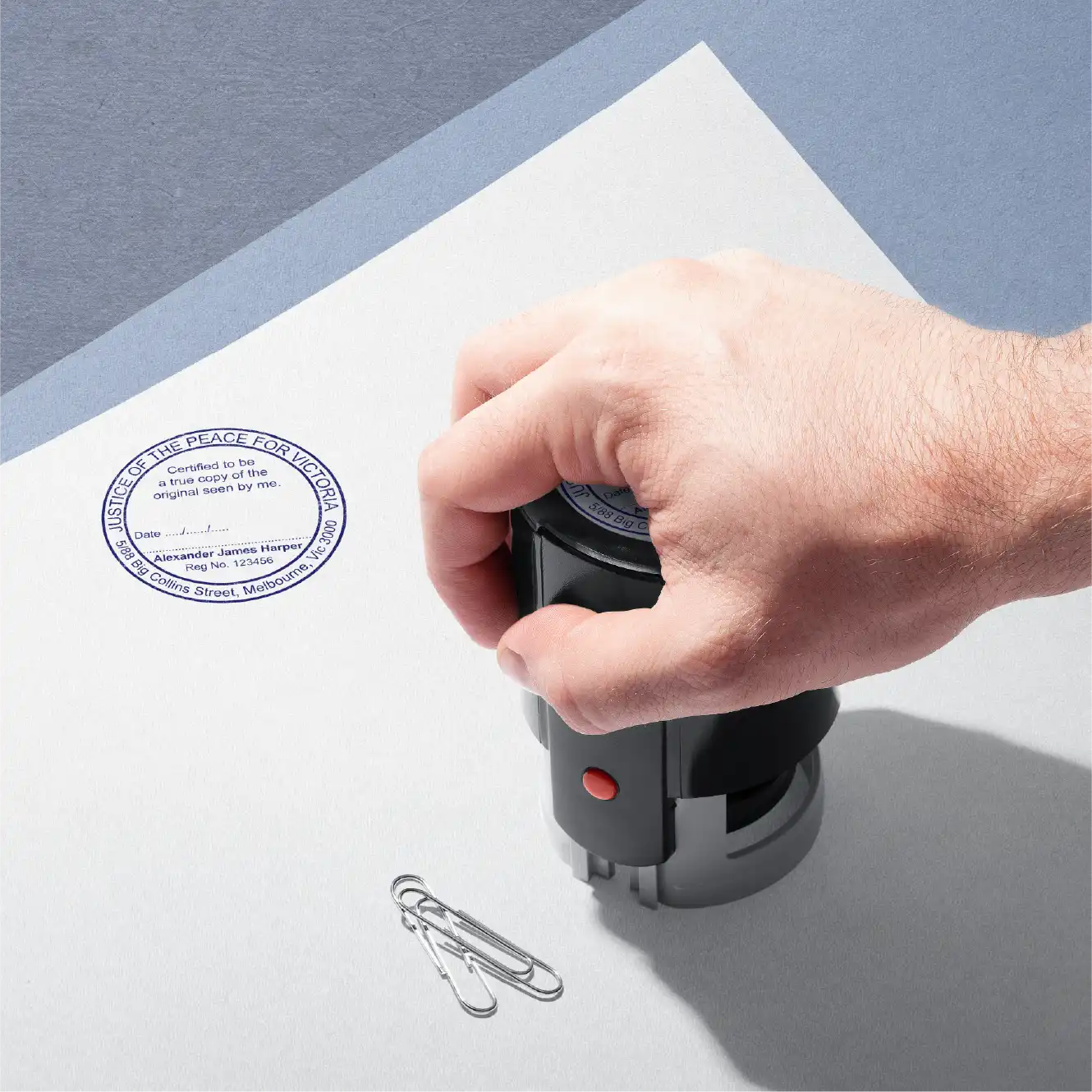 mans hand stamping custom Vic JP rubber stamper