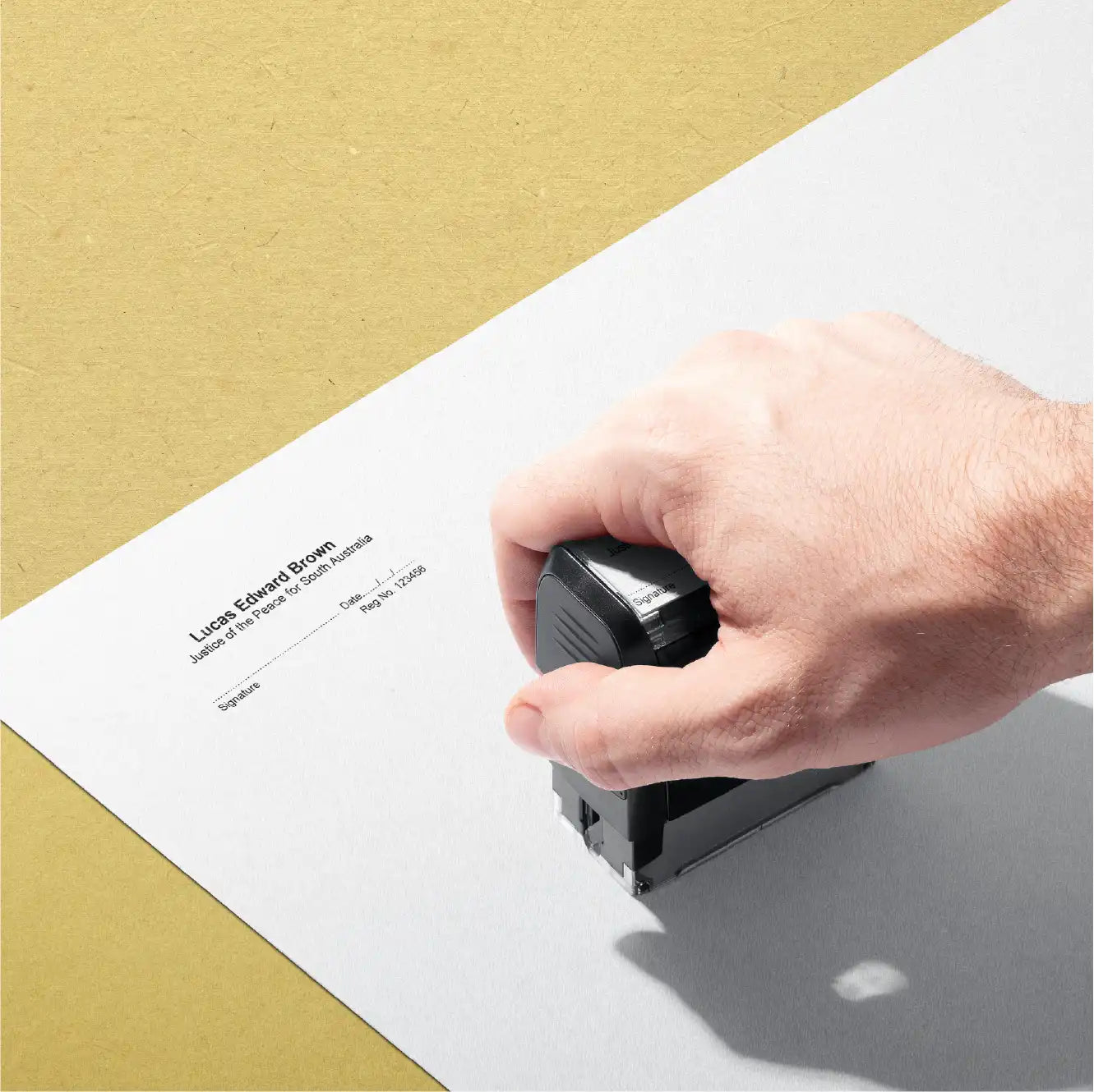 Disembodied hand stamping personalised SA JP stamp might be a shaved Bigfoot or Yowie