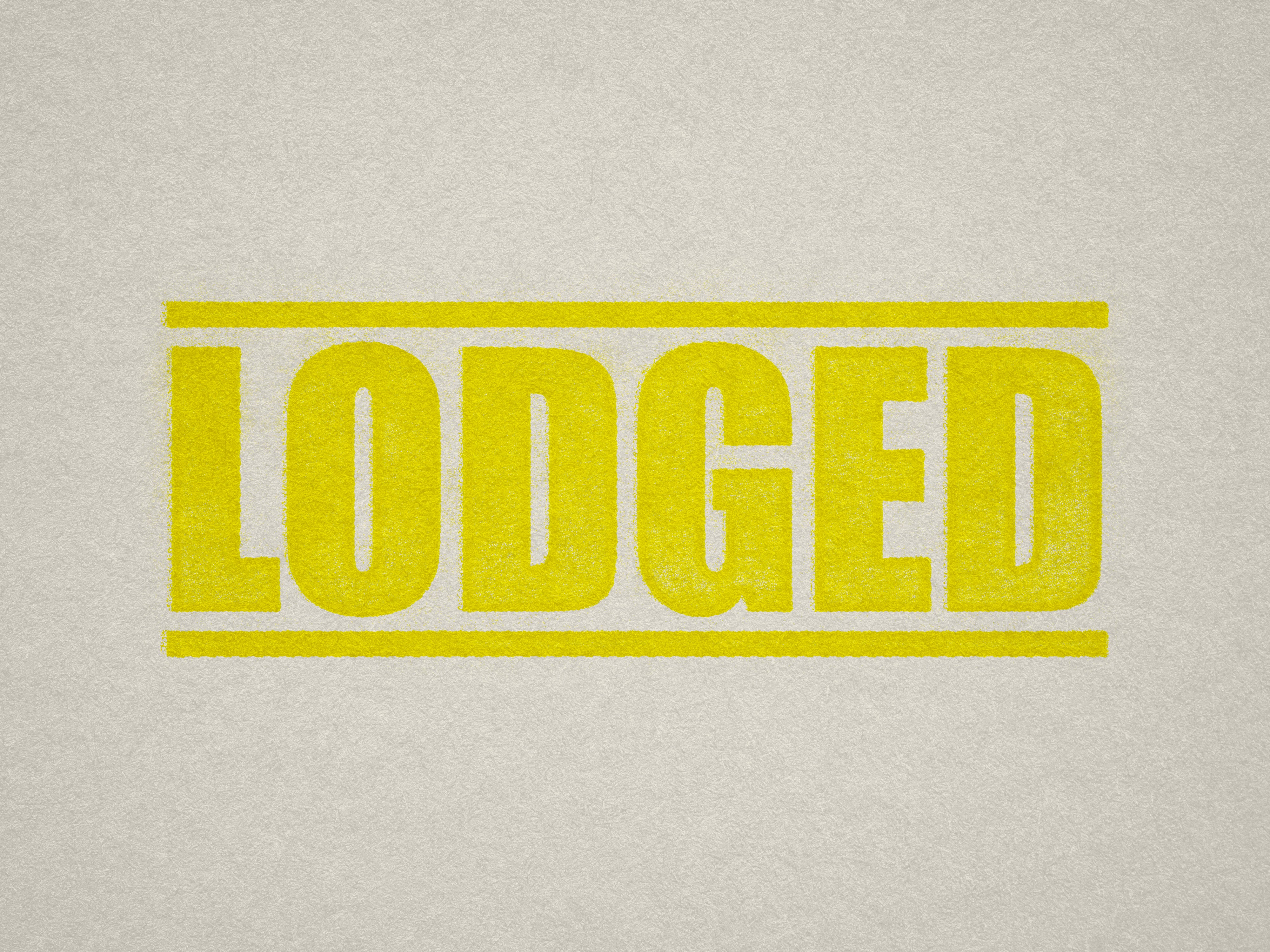 mock up design of 'Lodged' rubber stamp yellow ink in paper background stampers hand stamp office business inventory documents