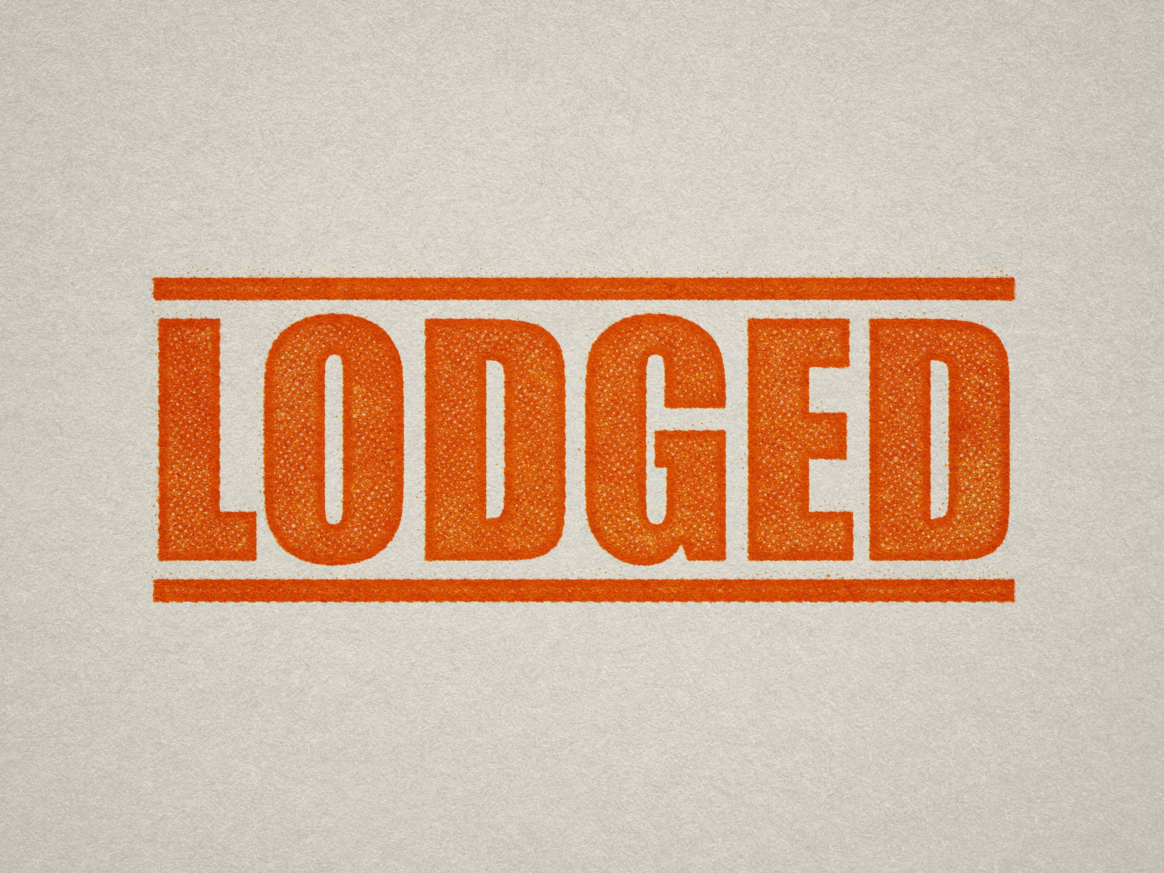 mock up design of 'Lodged' rubber stamp orange ink in paper background stampers hand stamp office business inventory documents