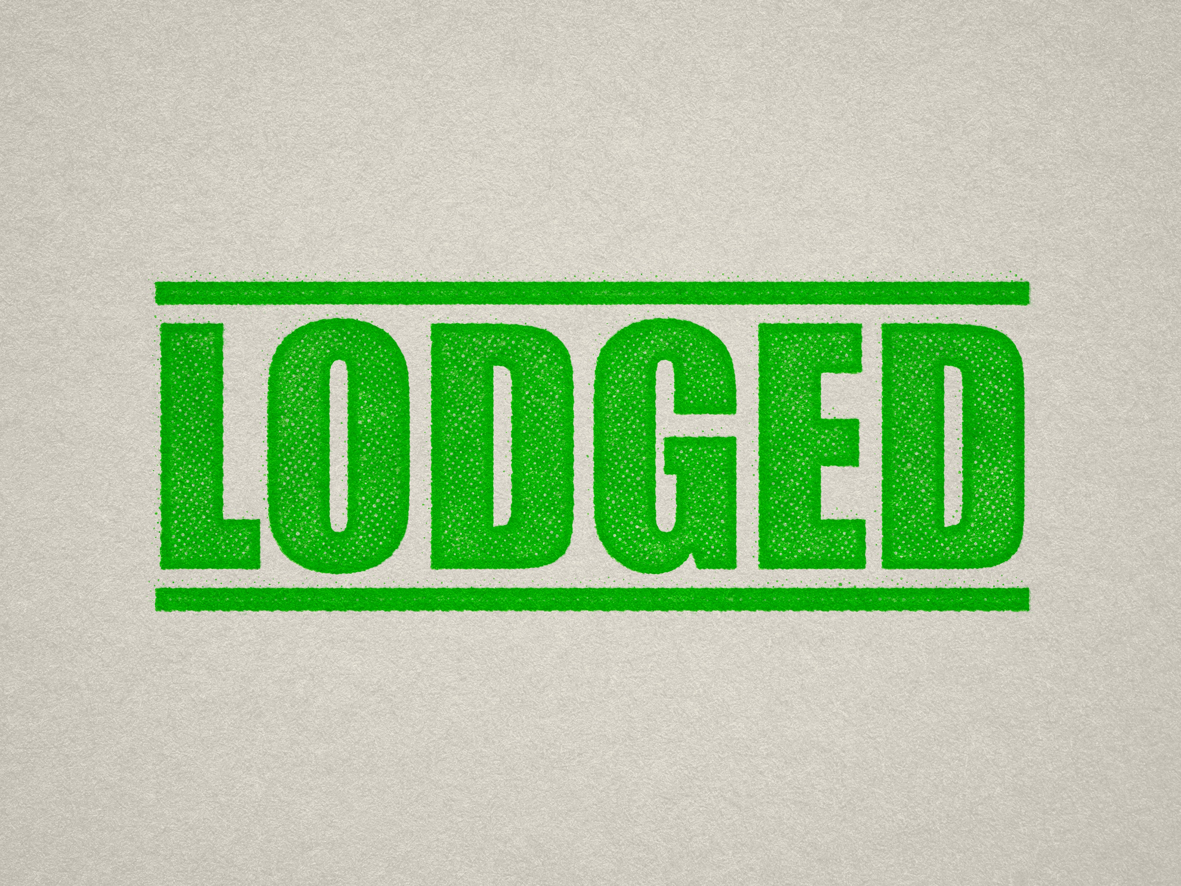 mock up design of 'Lodged' rubber stamp apple green ink in paper background stampers hand stamp office business inventory documents