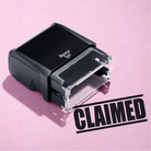 mock up design or lifestyle image of 'Claimed' rubber stamp black ink in paper background stampers hand stamp office business inventory documents self inking prefill refillable stamps stamping 
