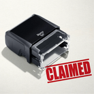 mock up design or lifestyle image of 'Claimed' rubber stamp red ink in paper background stampers hand stamp office business inventory documents self inking prefill refillable stamps stamping 
