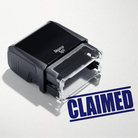 mock up design or lifestyle image of 'Claimed' rubber stamp blue ink in paper background stampers hand stamp office business inventory documents self inking prefill refillable stamps stamping 

