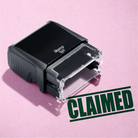 mock up design or lifestyle image of 'Claimed' rubber stamp green ink in paper background stampers hand stamp office business inventory documents self inking prefill refillable stamps stamping 

