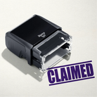 mock up design or lifestyle image of 'Claimed' rubber stamp violet ink in paper background stampers hand stamp office business inventory documents self inking prefill refillable stamps stamping purple
