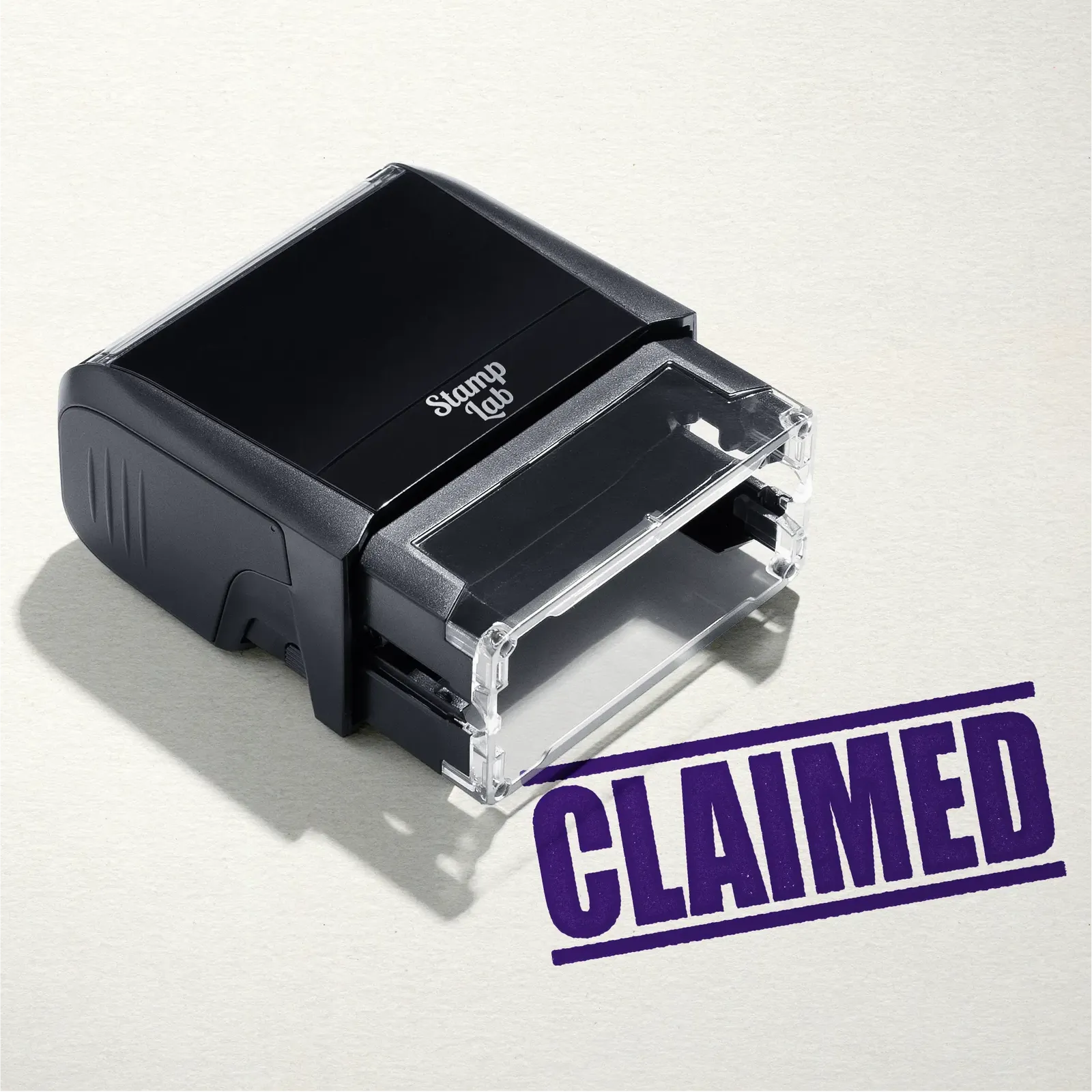 mock up design or lifestyle image of 'Claimed' rubber stamp violet ink in paper background stampers hand stamp office business inventory documents self inking prefill refillable stamps stamping purple
