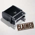 mock up design or lifestyle image of 'Claimed' rubber stamp brown ink in paper background stampers hand stamp office business inventory documents self inking prefill refillable stamps stamping 

