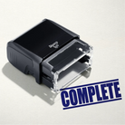 mock up design or lifestyle image of 'Complete' rubber stamp blue ink in paper background stampers hand stamp office business inventory documents
