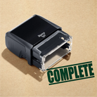 mock up design or lifestyle image of 'Complete' rubber stamp green ink in paper background stampers hand stamp office business inventory documents
